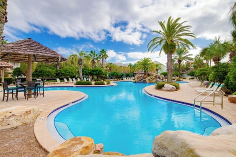 Dive into crystal-clear waters surrounded by swaying palms and tropical landscaping in this resort-style oasis.