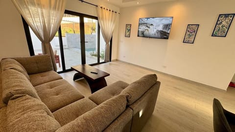Living room with walkout to the patio and refreshing private plunge pool.