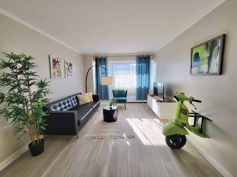 A stylish and modern living space filled with natural light, featuring sleek furnishings and a cozy ambiance.