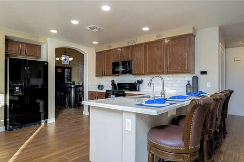 Chef's Delight! This spacious, well-stocked kitchen features counter seating - perfect for cooking and gathering!