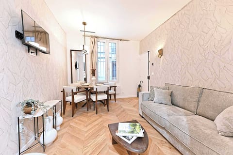 Salon avec canapé lit, TV et espace repas pour 4 personnes