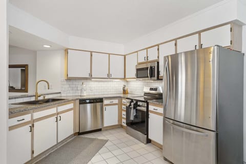 The bright, airy kitchen offers ample space & every home comfort