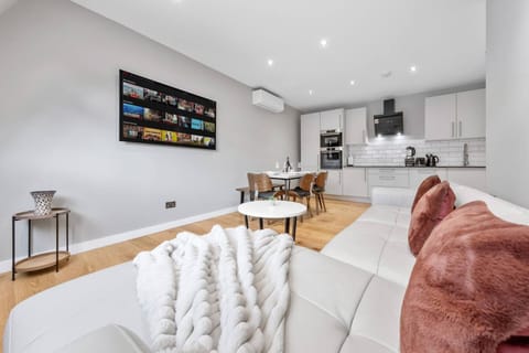 Bright lounge with smart TV and cozy seating for relaxing evenings.