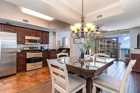 The dining table sits between the kitchen and balcony, making meals feel relaxed and connected.