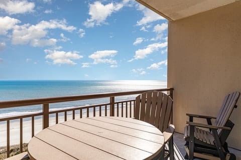 A round table on the balcony sets the tone for slow meals with the Atlantic just beyond the railing.