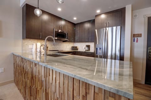 Modern kitchen with stainless steel appliances.