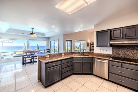 Kitchen area is offering serene view of the pool & ocean