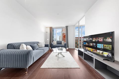 Bright and stylish living room with stunning city views from the heart of a modern high-rise