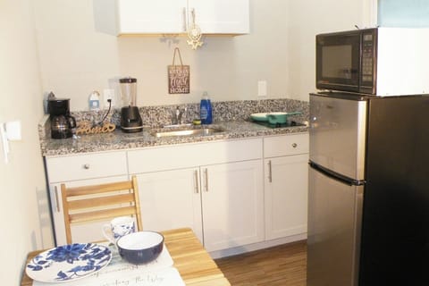 Private Kitchen with all necessary utensils to cook  something basic. it has 2 electric burners, microwave, small fridge, coffee maker and blender.