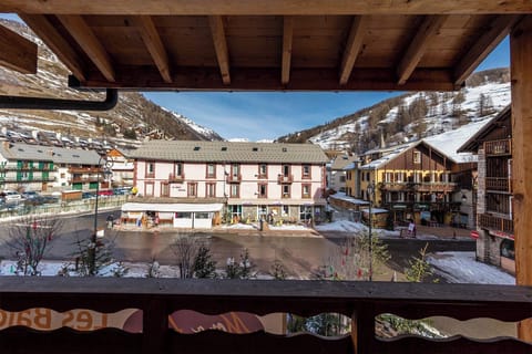 A stunning balcony view capturing the beauty of the residence and the surrounding winter wonderland.