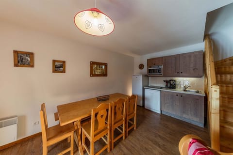 Spacious dining and kitchen area with rustic wooden decor, perfect for enjoying meals together after a day in the mountains.