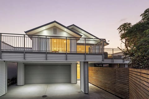 View of house from driveway.  Large deck upstairs with sliding doors into the lounge and dining areas.