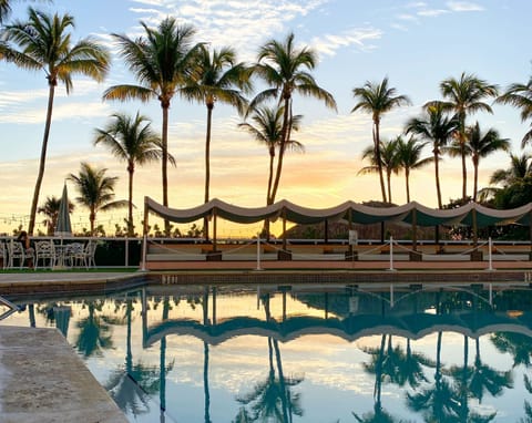 Savor sunset reflections while the pool glows with calm.
