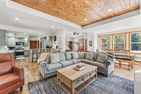 Main floor open concept living area with gas fireplace and smart TV