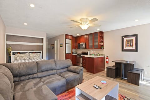 Studio living room with Smart TV, gas fireplace, dining area and murphy bed