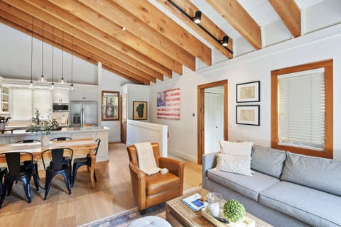 Open Living space with pull out sofa, TV, fireplace, and balcony