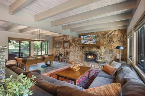 Cozy and spacious living area with Pool Table, TV, and Fireplace