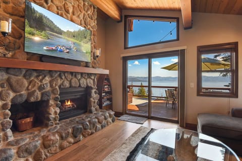 Living room with lake view, TV, fireplace