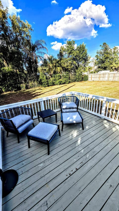 Back porch sitting area along with fully fenced backyard