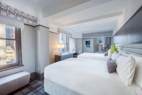 Wake up refreshed in crisp beds with bright city views.