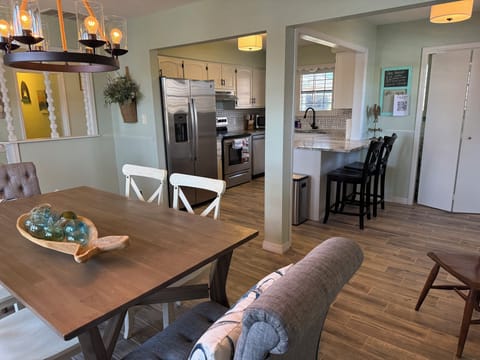 Kitchen with newer appliances, cookware, single serve Keurig, bar seating.