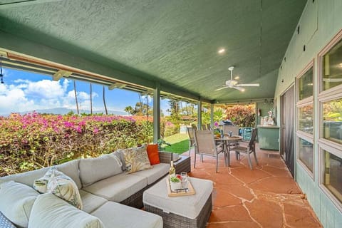 Relax in this inviting outdoor lounge with plush seating and tropical views