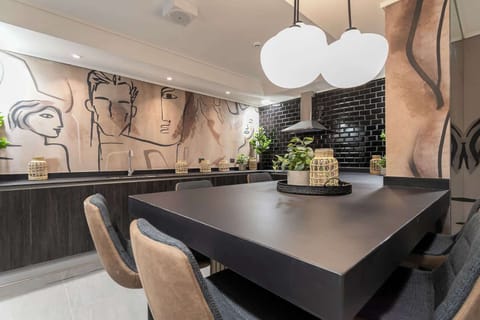 Experience culinary bliss in this spacious, modern kitchen adorned with artistic flair and stylish finishes, perfect for creating memorable meals.