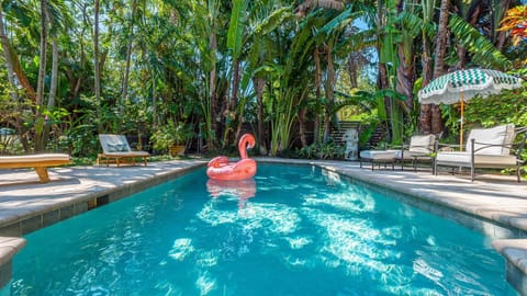 Your private outdoor paradise awaits! Lounge by the large heated pool, surrounded by lush tropical landscaping, or enjoy alfresco dining on the covered patio. With a gas grill, bistro set, and sun loungers, relaxation is guaranteed.