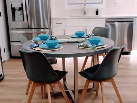 Bright dining table next to a sleek kitchen