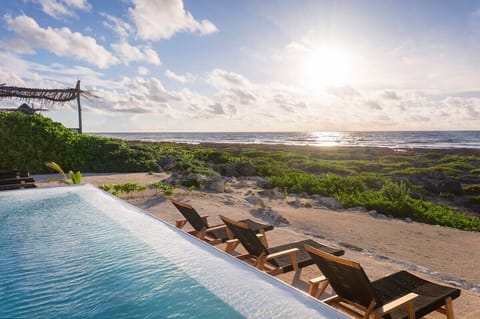 Impressive infinity pool with a view of the sea. Comfortable sun loungers for relaxation.
