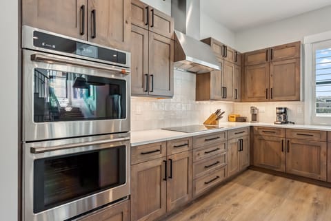 Double ovens, range, and ample top-of-the-line kitchen supplies