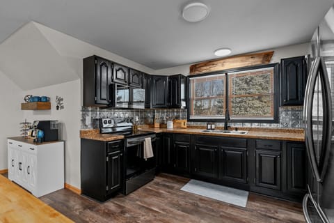 The kitchen features a glass-top stove and a microwave, offering modern conveniences for all your cooking needs.
