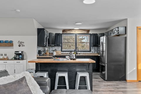 The large kitchen island provides extra seating, making it the ideal spot for casual meals or chatting while cooking.