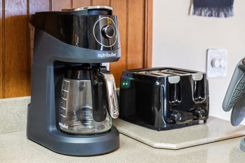 Kitchen is stocked with coffee maker and toaster.