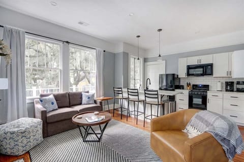Bright and inviting, the open living room features large windows that fill the space with natural light.