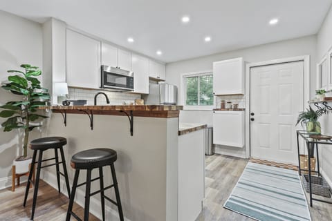 This charming bar with a warm wood countertop seats 2—perfect for morning coffee or evening cocktails.