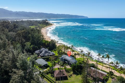 Maluhia Beach House sits at the end of a quiet road, nestled next to infamous uninhabited beach front with Kaena Point in the distance.