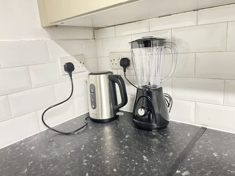 The spacious kitchen combines contemporary style with functionality, offering a large island, ample storage, and a bright, welcoming atmosphere.