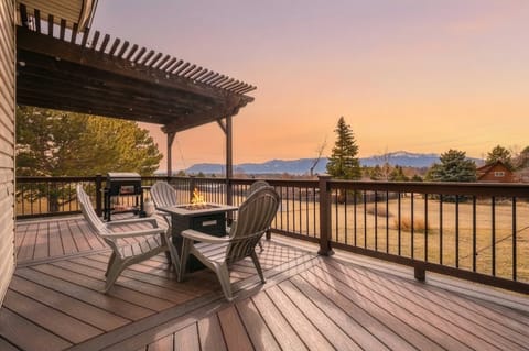 Step outside to the expansive wood deck to enjoy panoramic views of the Colorado landscape. Featuring a pergola for shade, a gas fire table, and a propane grill, this outdoor oasis is perfectly designed for dining and sunset watching..