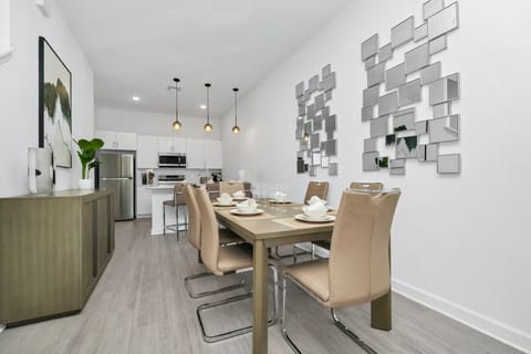 The dining area featured a rustic wooden table surrounded by comfortable chairs, perfect for enjoying meals with family and friends against a backdrop of softly glowing candles.