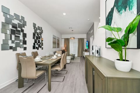 The dining area featured a rustic wooden table surrounded by comfortable chairs, perfect for enjoying meals with family and friends against a backdrop of softly glowing candles.