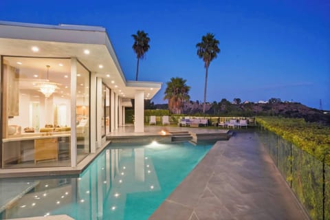 A sleek, private pool framed by palm trees and iconic views for ultimate relaxation.