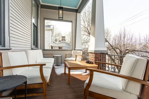 A front patio featuring comfortable outdoor furniture, including chairs and a table, creating a cozy and inviting space to relax and enjoy the outdoors.