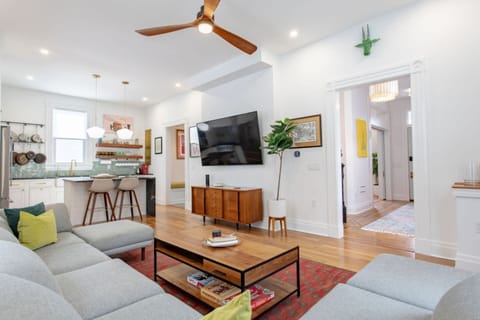 A cozy living area with plush couches arranged around a spacious center table, offering a perfect setting for relaxation and socializing.