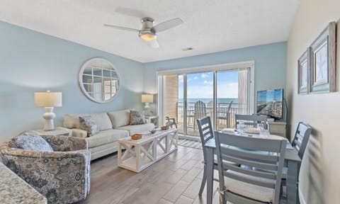 View of living room, dining table, and oceanfront views