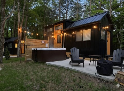 Soak under the stars in your personal hot tub, warm up by the fire with cozy Adirondack seating, and grill dinner surrounded by towering pines—your perfect woodland retreat awaits.