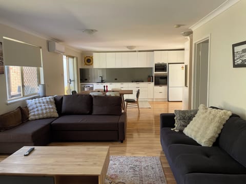 Spacious, light filled open plan living, 2 full couches and a full kitchen 