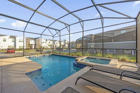 Relax in your private screened pool and hot tub, perfect for unwinding after a day of adventure. Enjoy the serene setting and ample lounging space.