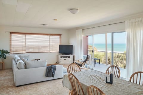 Sink into the L-shaped sofa or rocking chair as you take in breathtaking ocean views from the private balcony, with a TV ready for group movie nights.