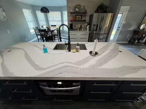 4 x 10 ft island that houses microwave, dishwasher, trash compactor & sink